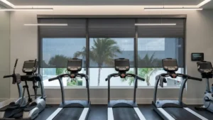 Modern gym interior with custom blinds on large windows, providing privacy, controlling light, and enhancing comfort and style